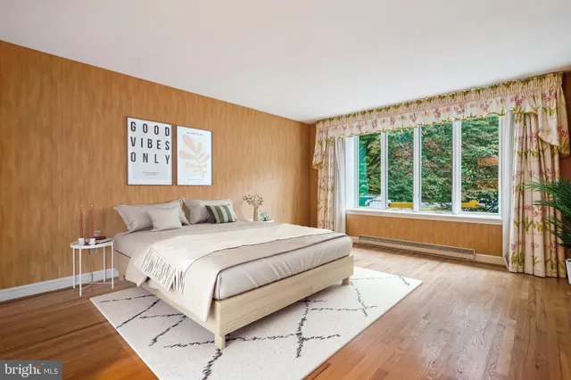 a spacious bedroom with a large bed and a large window