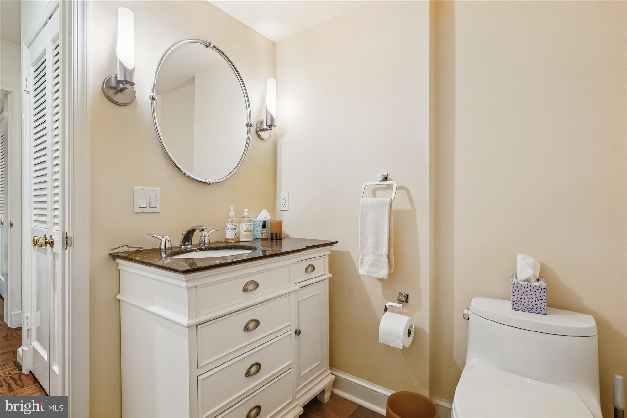 702 Belgrove Road McLean, VA 22101 - Photo 42 of 52 a bathroom with a granite countertop toilet a sink and a mirror