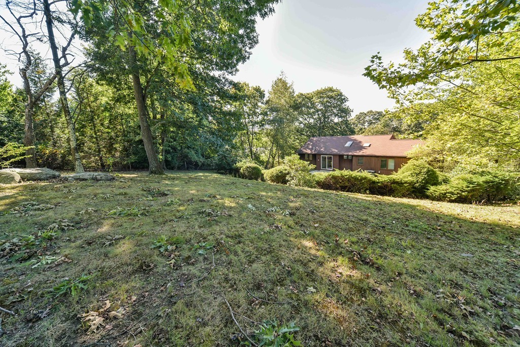 54 Drumlin Road Newton, MA 02459 - Photo 2 of 12 a backyard of a house with lots of green space