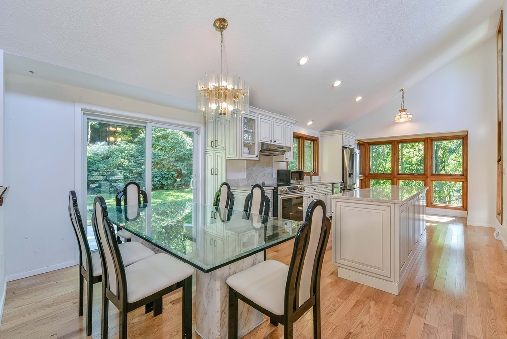 54 Drumlin Road Newton, MA 02459 - Photo 7 of 12 a dining room with furniture a chandelier and wooden floor