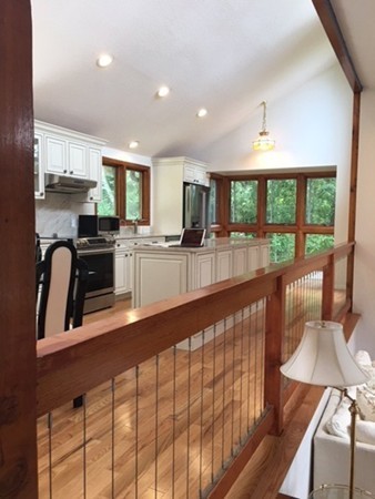 54 Drumlin Road Newton, MA 02459 - Photo 8 of 12 a kitchen with stainless steel appliances kitchen island granite countertop a refrigerator a stove a sink and dishwasher with wooden floor
