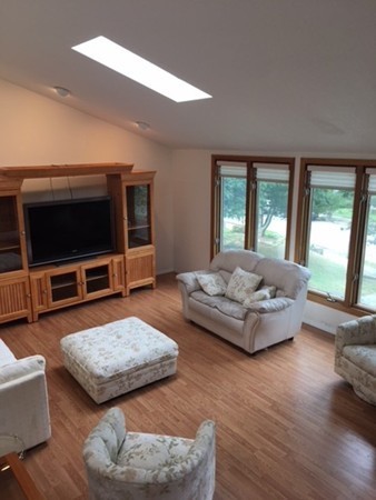 54 Drumlin Road Newton, MA 02459 - Photo 9 of 12 a living room with furniture and a flat screen tv