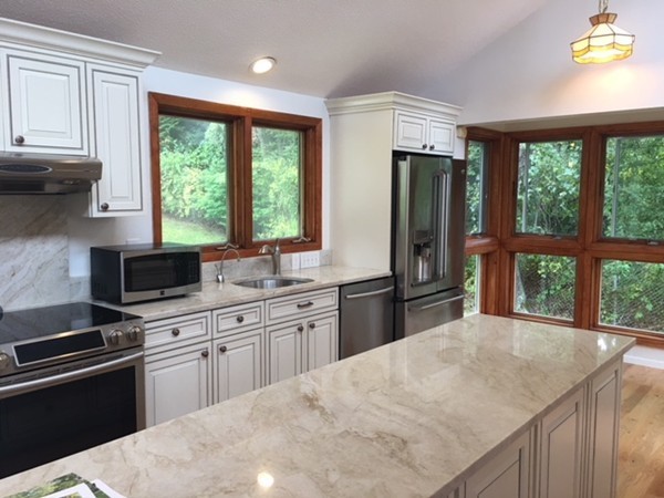 54 Drumlin Road Newton, MA 02459 - Photo 10 of 12 a kitchen with a stove a sink a refrigerator and a window