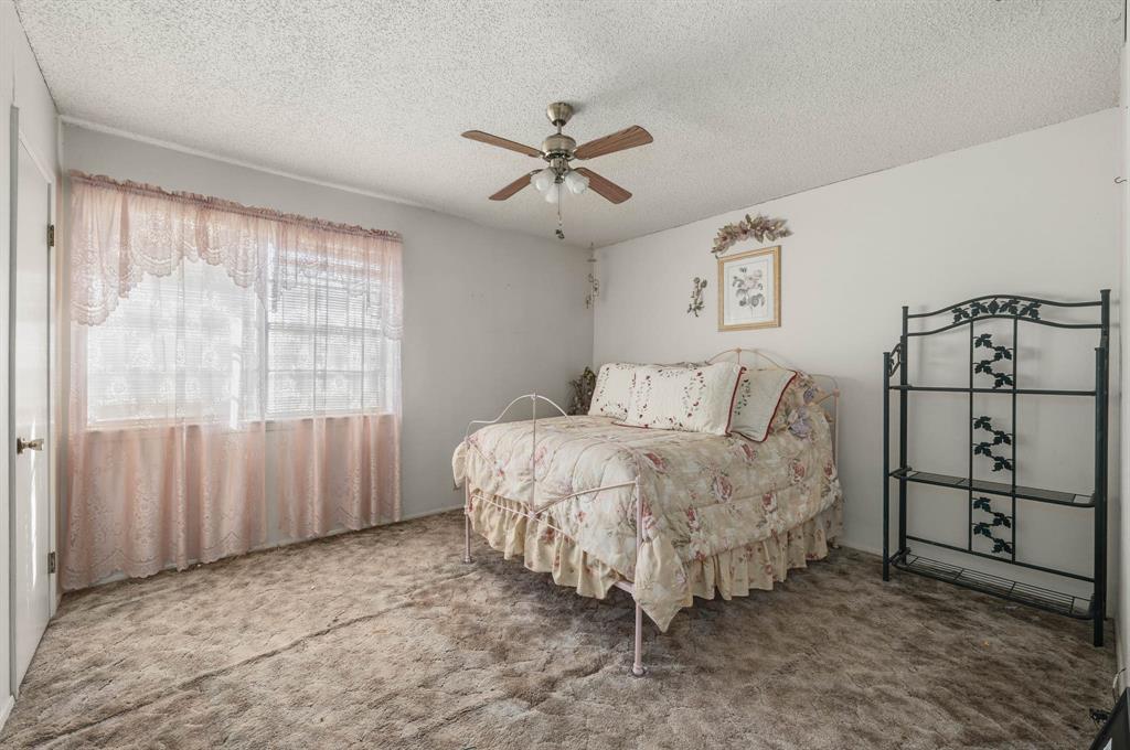 3692 Fm 66 Grandview, TX 76050 - Photo 13 of 39 a spacious bedroom with a bed and a window
