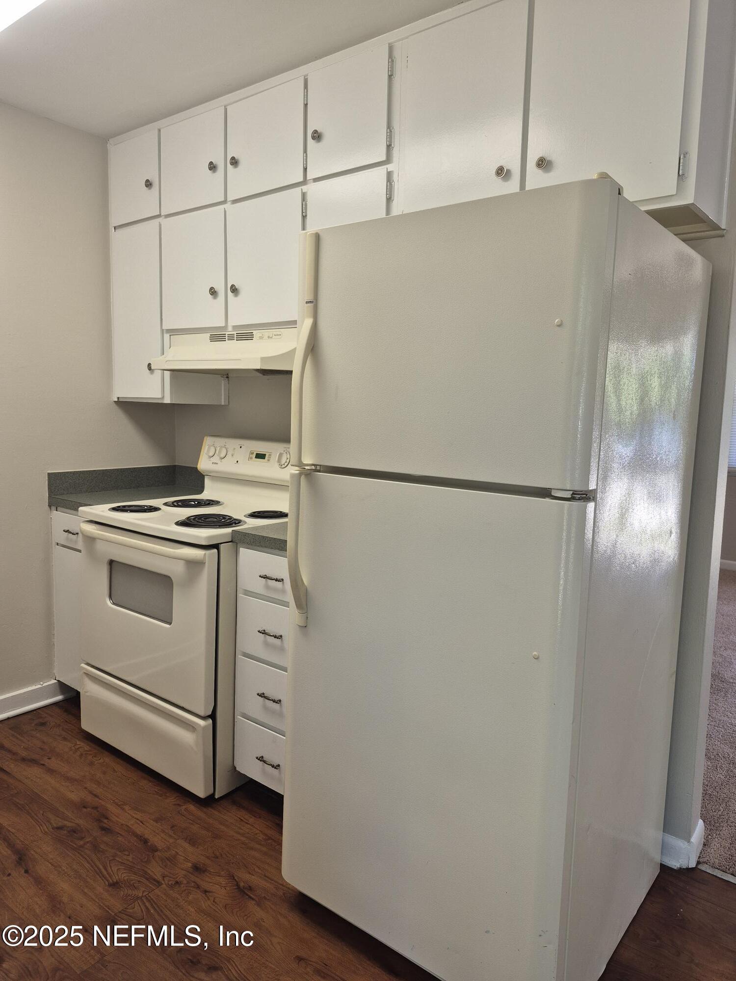 223 Edson Drive Orange Park, FL 32073 - Photo 11 of 21 a white refrigerator freezer and a stove sitting inside of a kitchen