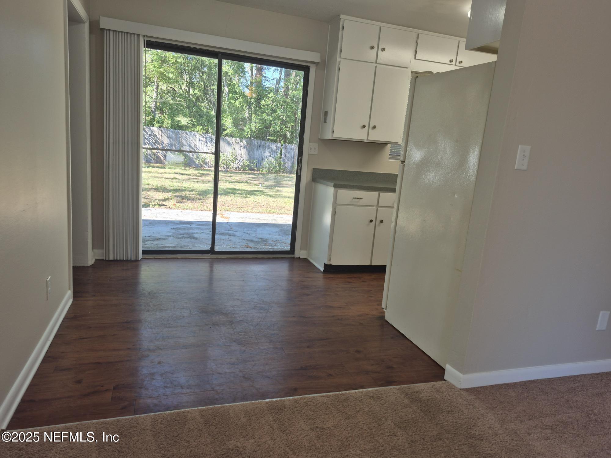 223 Edson Drive Orange Park, FL 32073 - Photo 9 of 21 an empty room with wooden floor and windows
