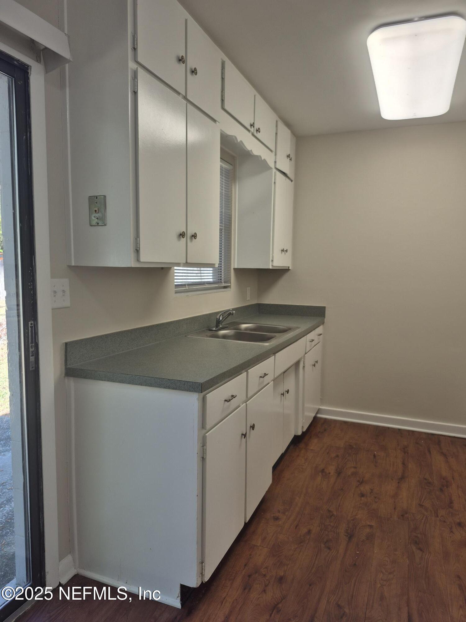 223 Edson Drive Orange Park, FL 32073 - Photo 10 of 21 a kitchen with granite countertop white cabinets and white appliances