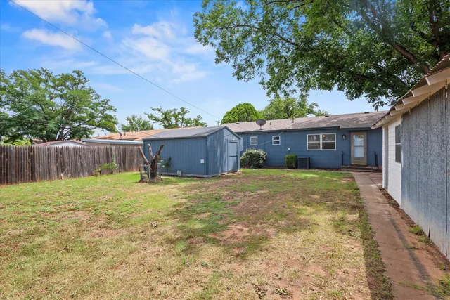a view of a house with a yard and a garage