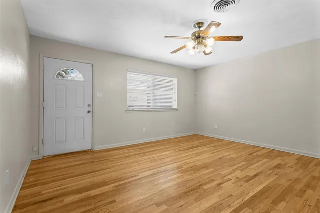 wooden floor in an empty room with a window