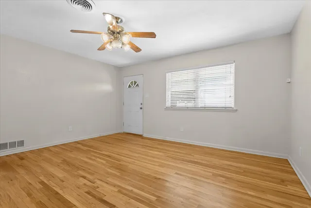 wooden floor in an empty room with a window