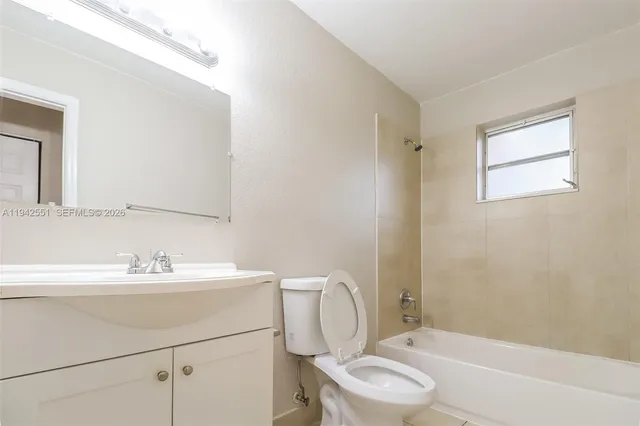 a bathroom with a sink toilet a mirror and shower