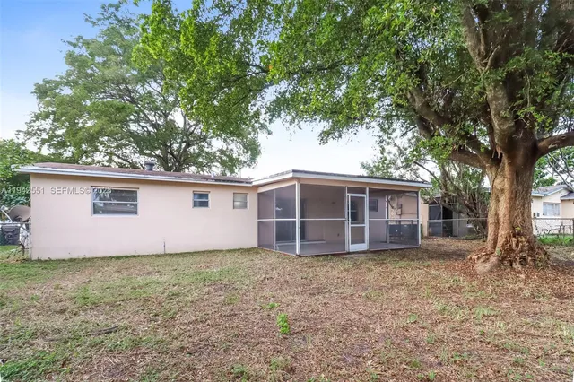 a house with trees in the background