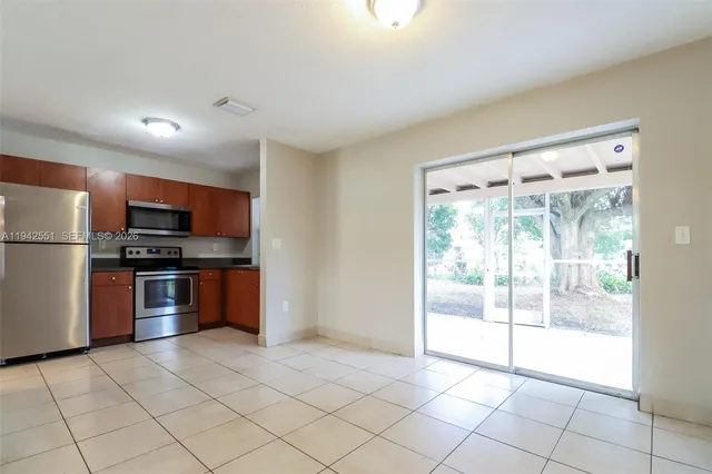 a kitchen with stainless steel appliances granite countertop a refrigerator and a sink