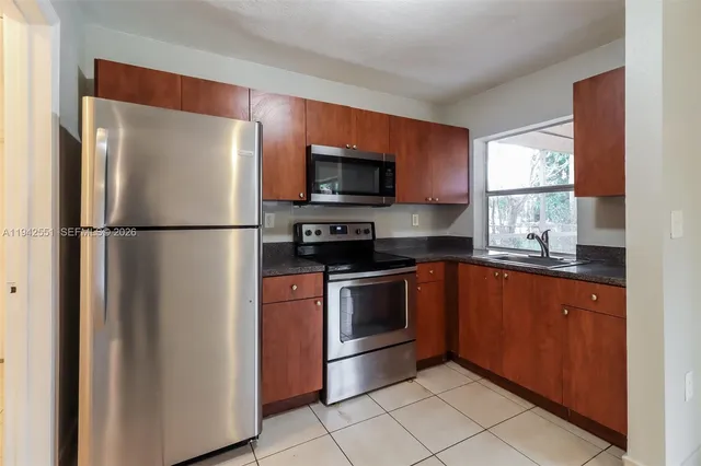 a kitchen with stainless steel appliances granite countertop a refrigerator and a sink