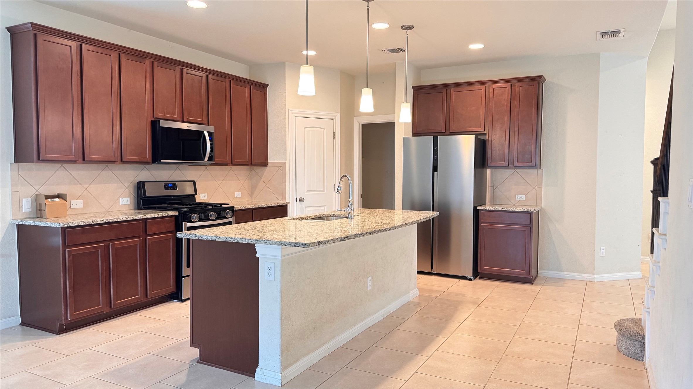 15912 Cessida Street Austin, TX 78728 - Photo 9 of 23 a kitchen with stainless steel appliances granite countertop a refrigerator stove a sink and a oven