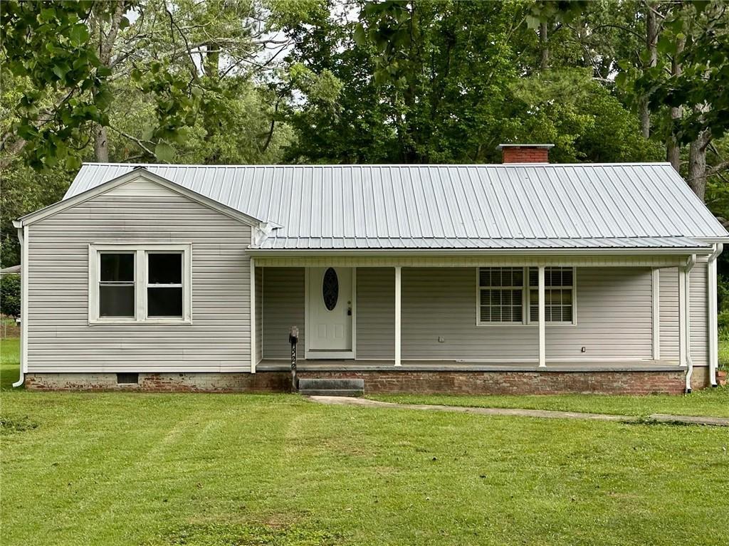 522 Peters Street Calhoun, GA 30701 - Photo 1 of 1 a front view of a house with a garden