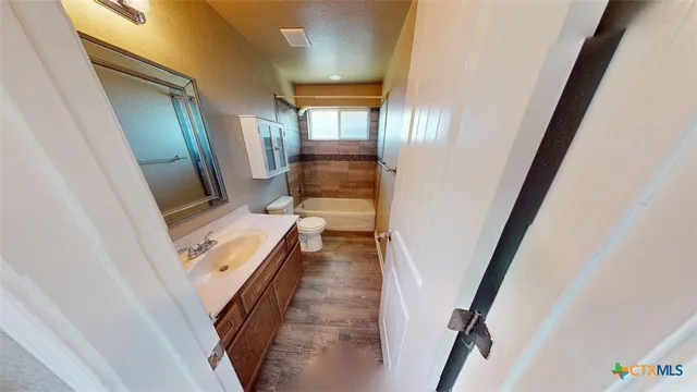 a view of a hallway and a livingroom with furniture
