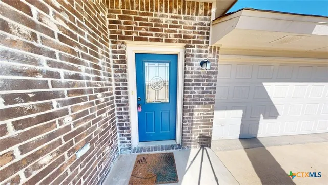 a view of a door with a door and wooden floor