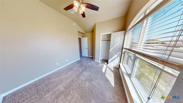 a view of an empty room and a window