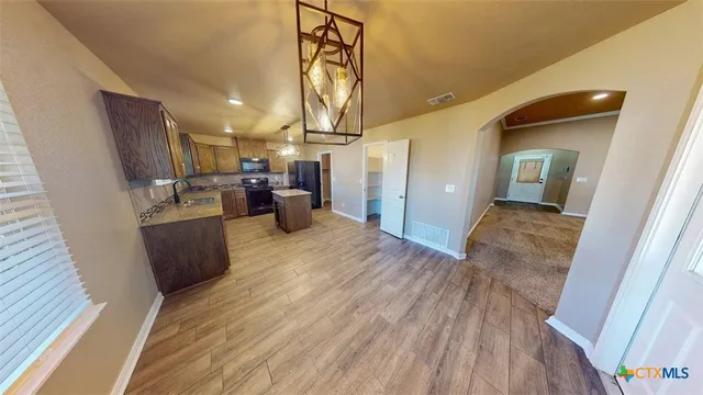 a view of a kitchen from the hallway