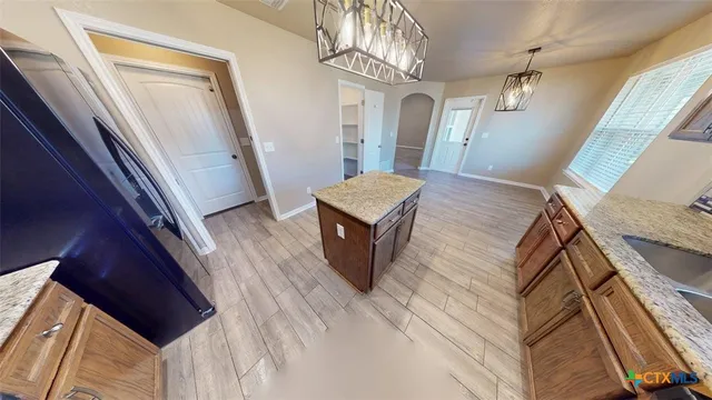 a view of a livingroom with wooden floor and stairs
