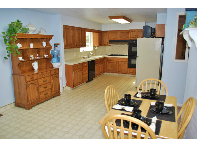 26928 Palomares Road Castro Valley, CA 94552 - Photo 10 of 10 a kitchen with stainless steel appliances a stove a refrigerator a sink a dining table and chairs