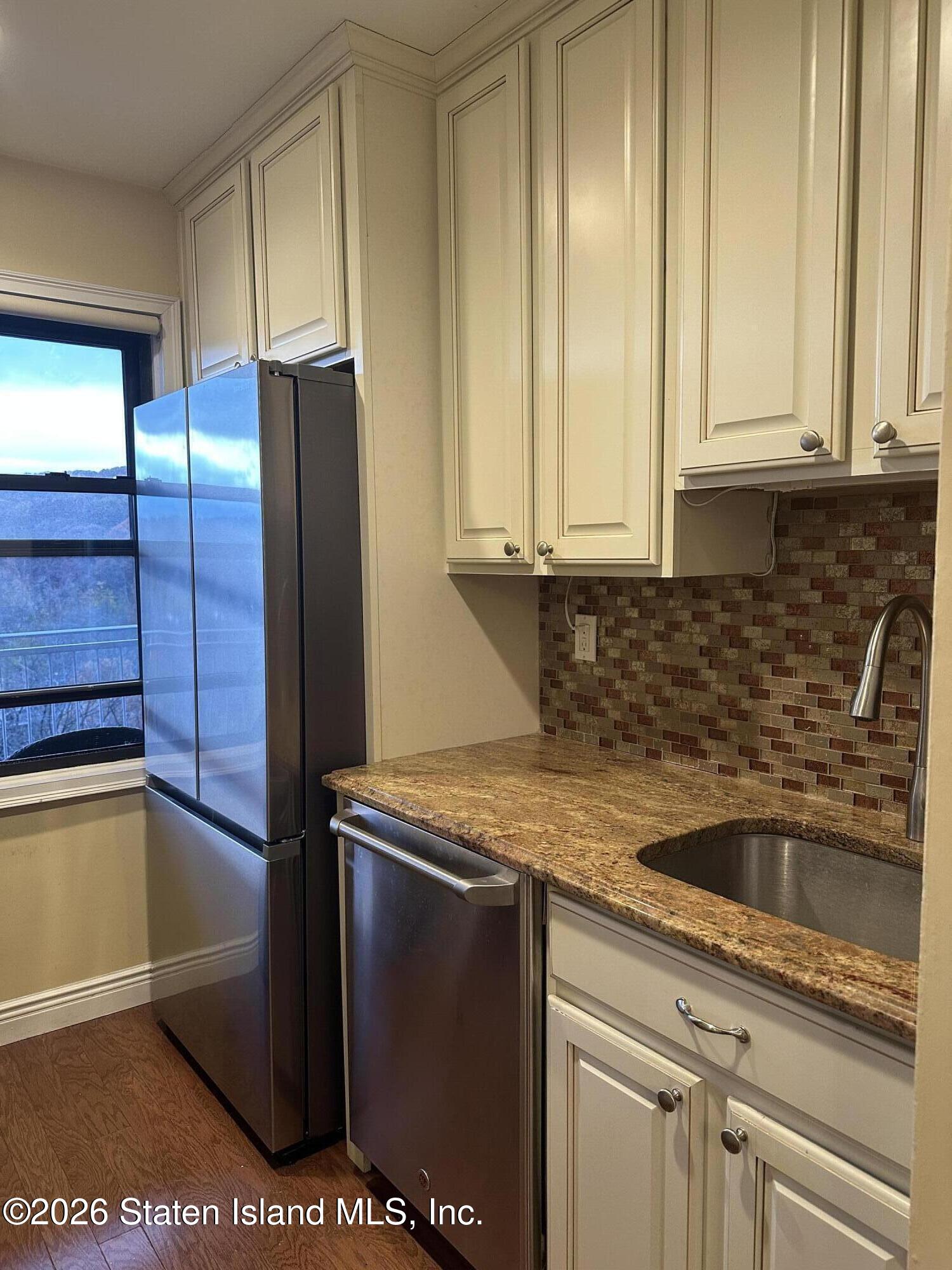 1100 Clove Road, Unit 7O Staten Island, NY 10301 - Photo 17 of 36 a kitchen with stainless steel appliances granite countertop a refrigerator and a sink