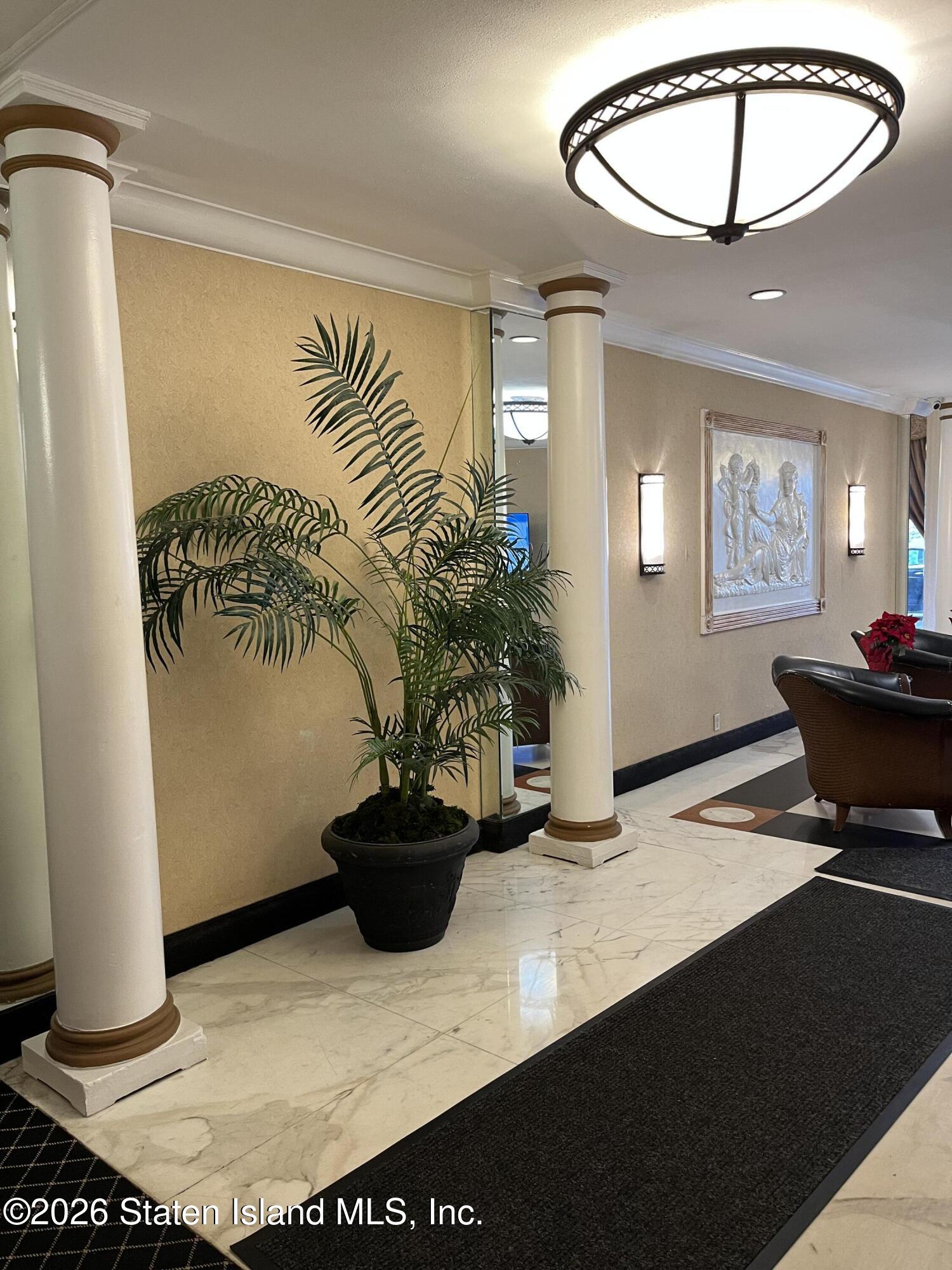 1100 Clove Road, Unit 7O Staten Island, NY 10301 - Photo 5 of 36 a living room with furniture and a potted plant