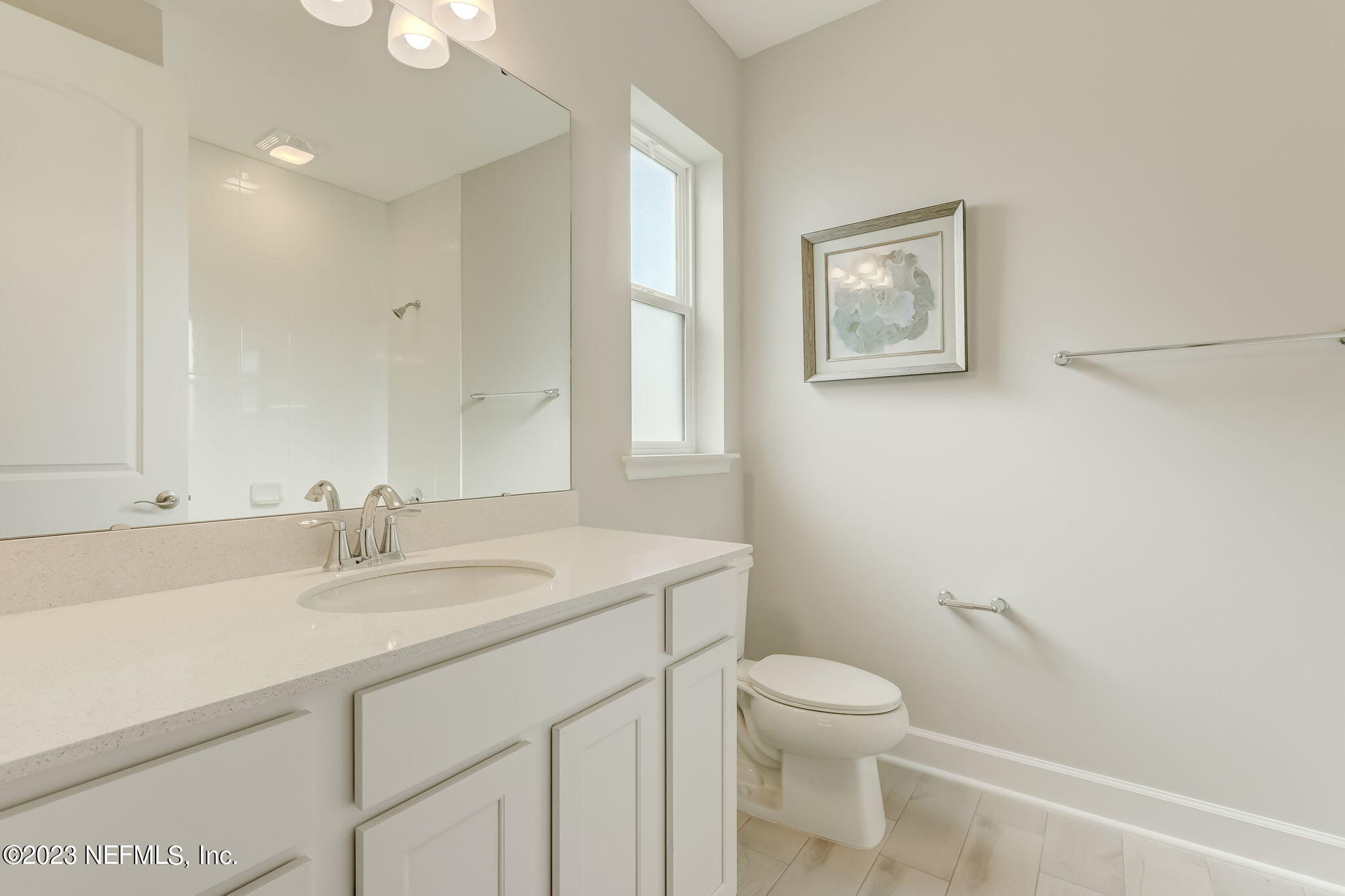 85164 Sandy Ridge Loop, Unit 19 Yulee, FL 32097 - Photo 18 of 23 a bathroom with a granite countertop toilet a sink a mirror and a window