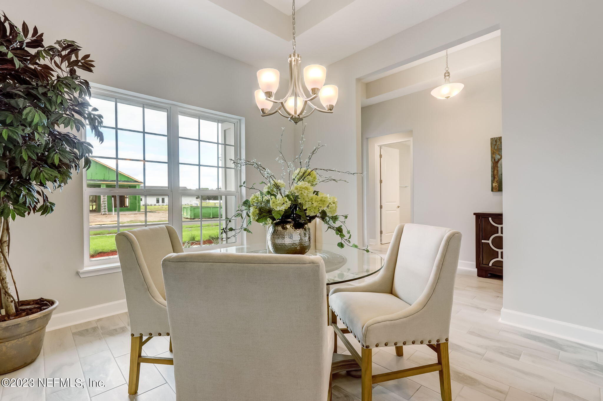 85164 Sandy Ridge Loop, Unit 19 Yulee, FL 32097 - Photo 4 of 23 a dining room with furniture and a potted plant