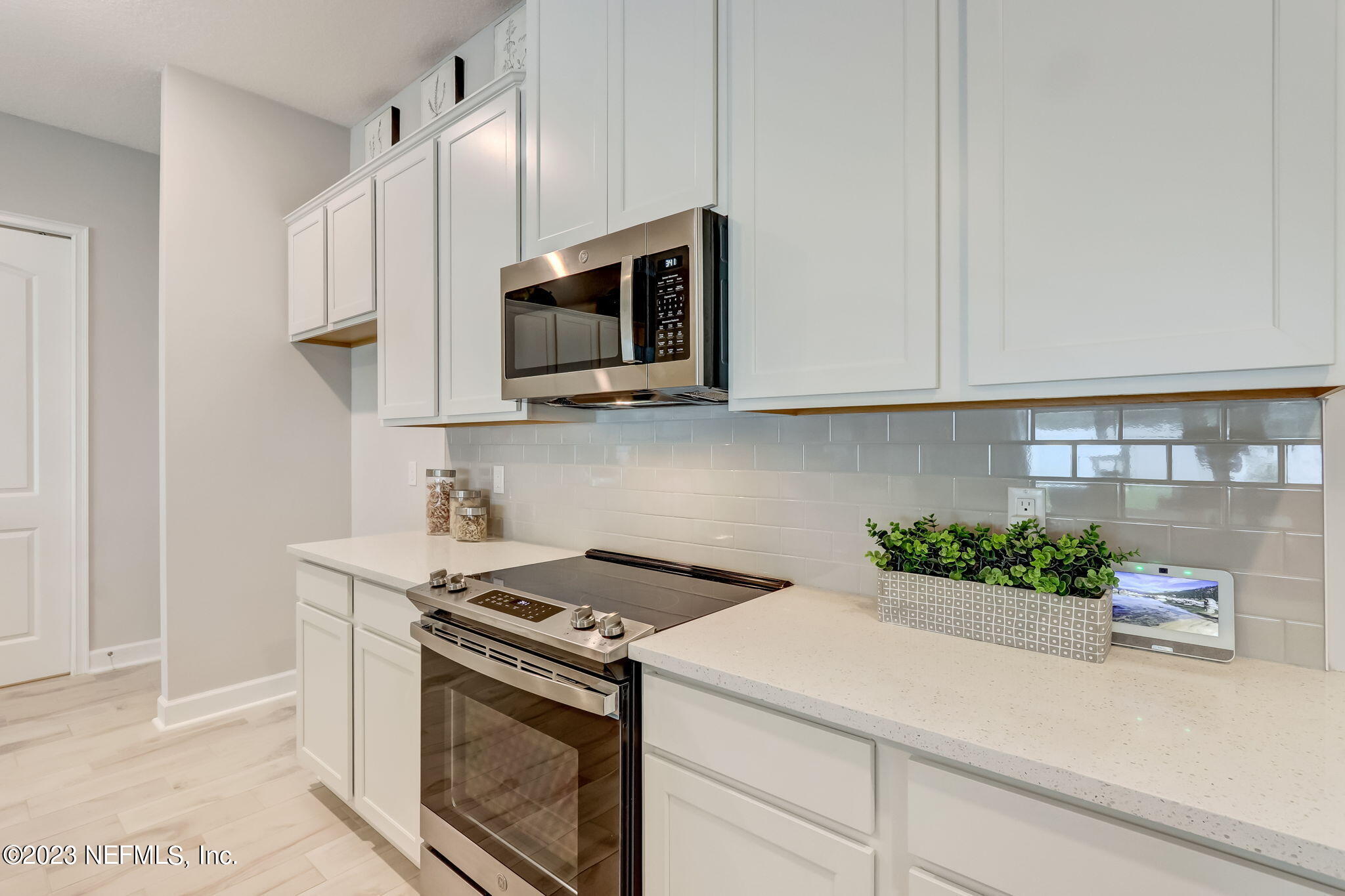 85164 Sandy Ridge Loop, Unit 19 Yulee, FL 32097 - Photo 7 of 23 a kitchen with stainless steel appliances white cabinets and a stove top oven
