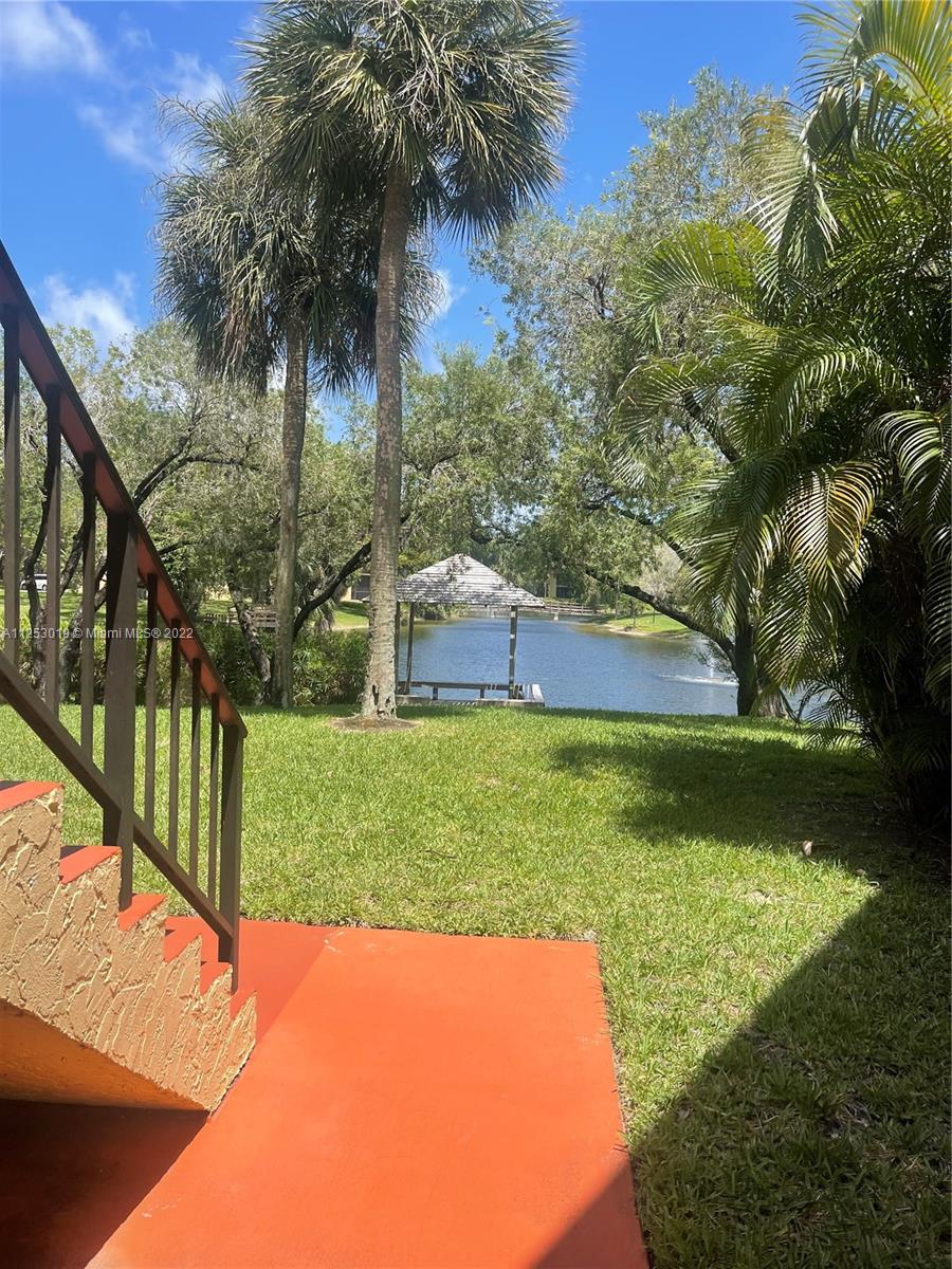 812 Southwest 9th St Circle, Unit 101 Boca Raton, FL 33486 - Photo 14 of 15 a view of yard with swimming pool and green space