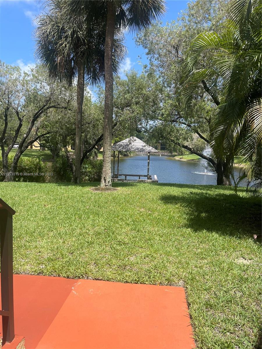812 Southwest 9th St Circle, Unit 101 Boca Raton, FL 33486 - Photo 2 of 15 a view of a house with a yard