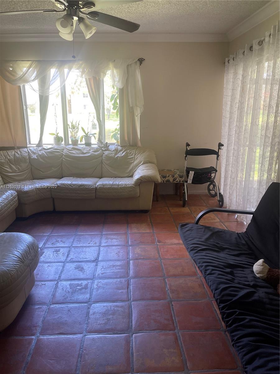 812 Southwest 9th St Circle, Unit 101 Boca Raton, FL 33486 - Photo 3 of 15 a living room with a couch and a table