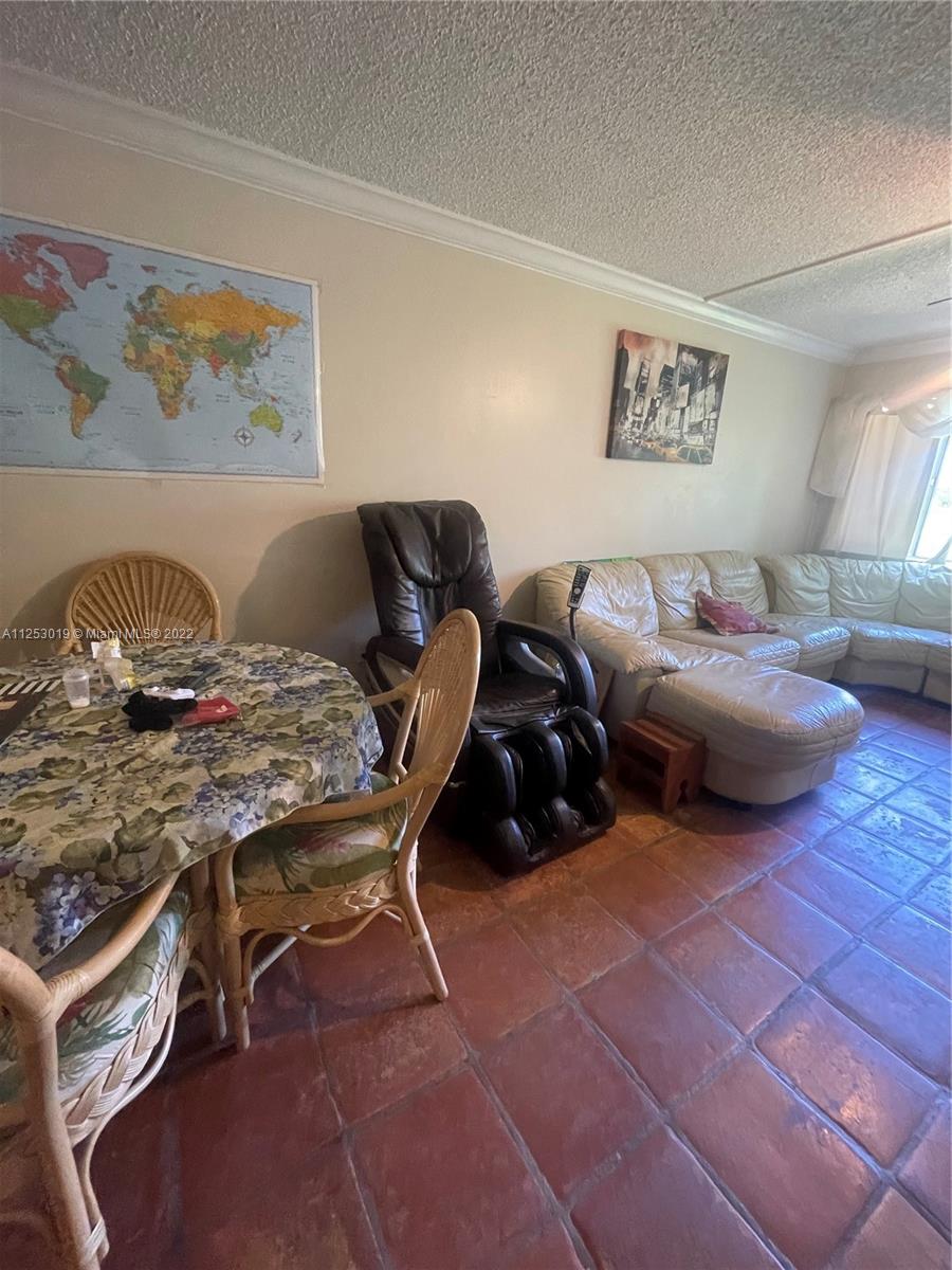 812 Southwest 9th St Circle, Unit 101 Boca Raton, FL 33486 - Photo 4 of 15 a living room with furniture and a window