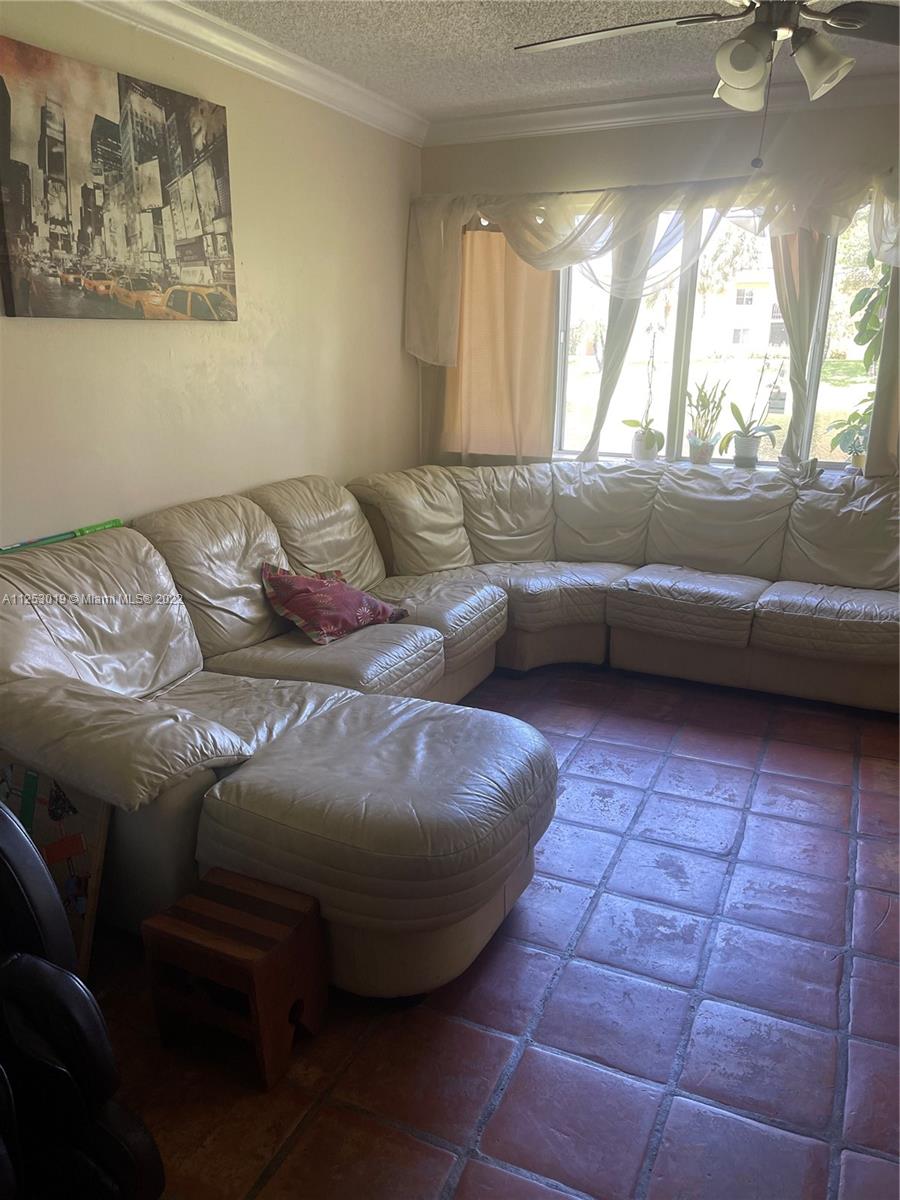 812 Southwest 9th St Circle, Unit 101 Boca Raton, FL 33486 - Photo 5 of 15 a living room with furniture and a window