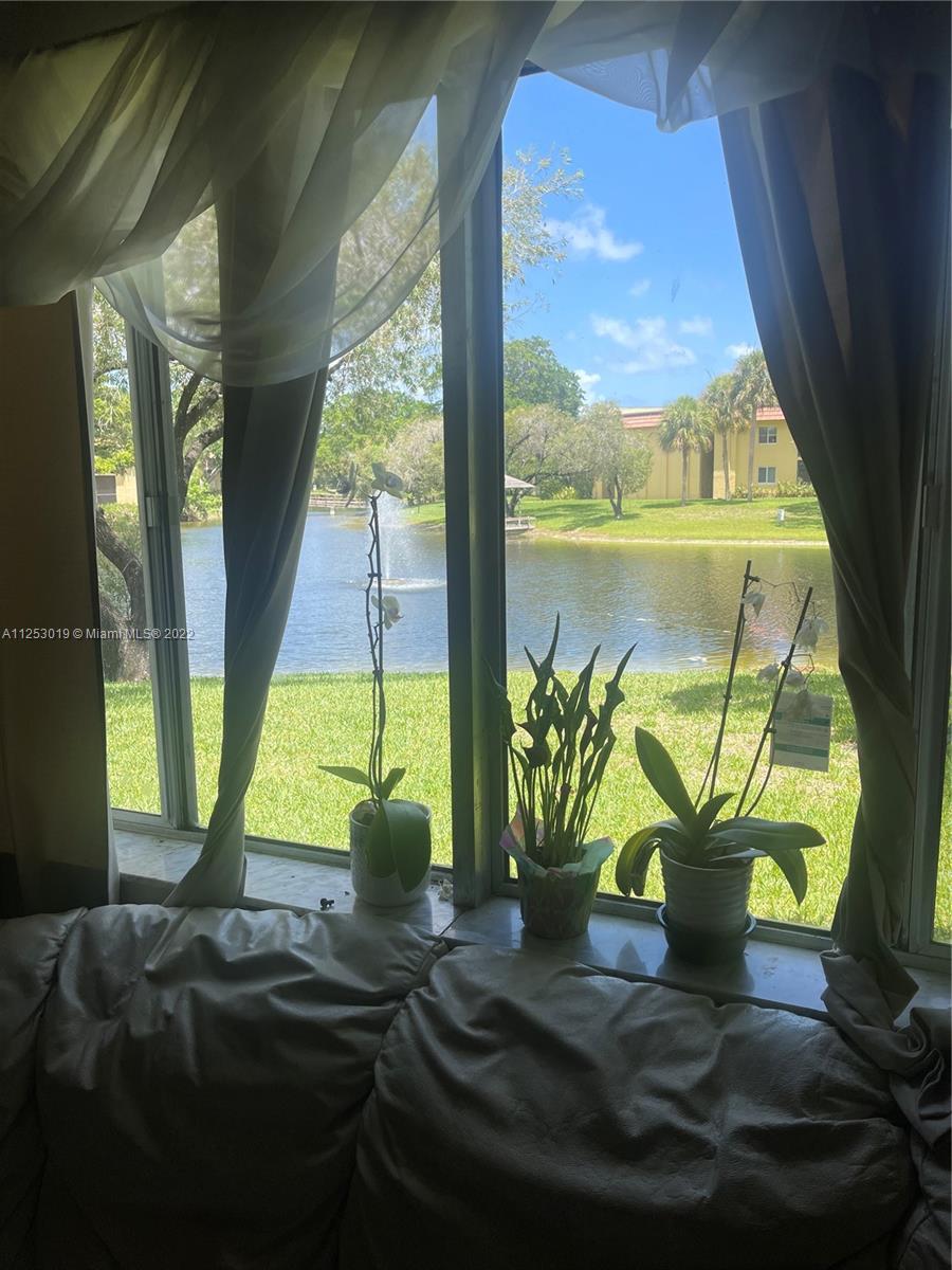 812 Southwest 9th St Circle, Unit 101 Boca Raton, FL 33486 - Photo 6 of 15 a view of a flower pot on a table near a window