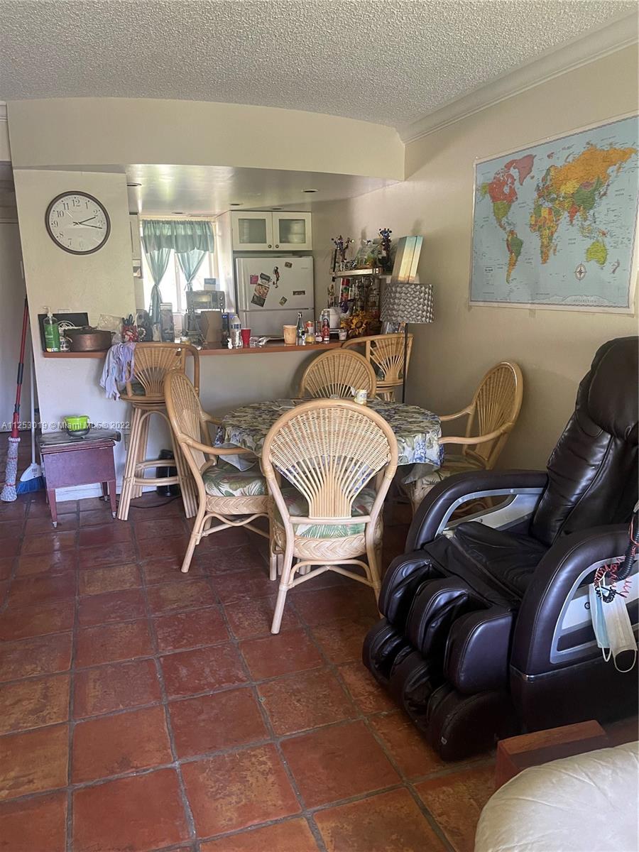812 Southwest 9th St Circle, Unit 101 Boca Raton, FL 33486 - Photo 7 of 15 a living room with furniture and a clock