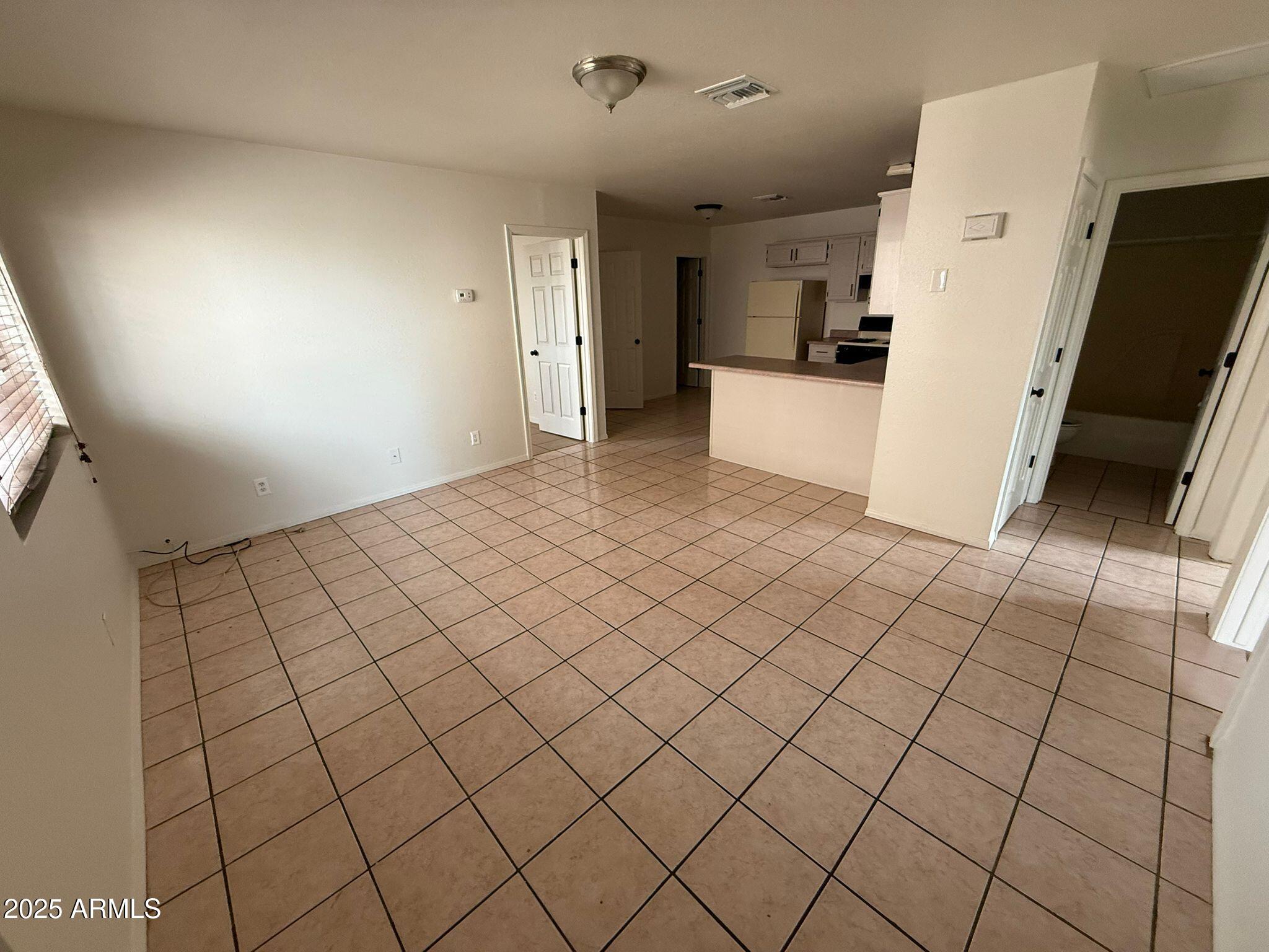 712 East 17th Street, Unit D Douglas, AZ 85607 - Photo 2 of 16 a view of a refrigerator and window in a kitchen