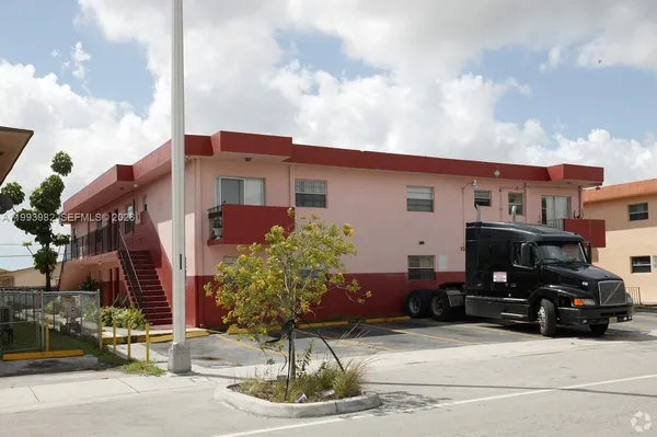 a car parked in front of a white building