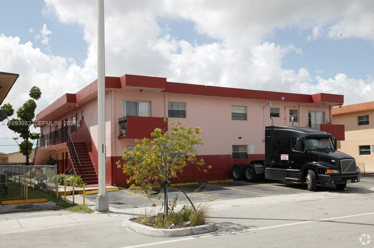 a car parked in front of a white building