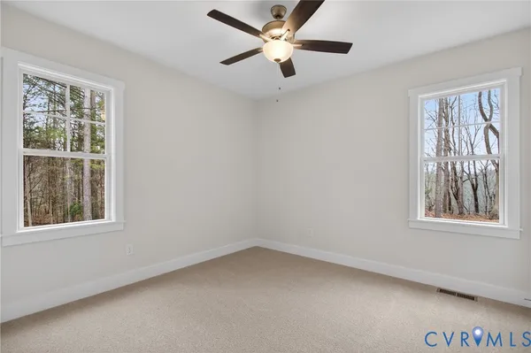 an empty room with a empty space and a ceiling fan