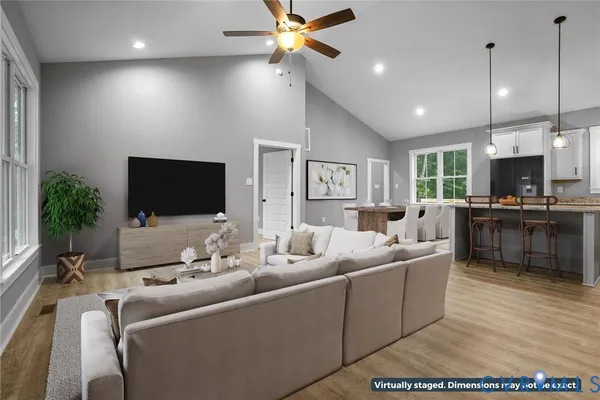 a large kitchen with cabinets wooden floor and stainless steel appliances