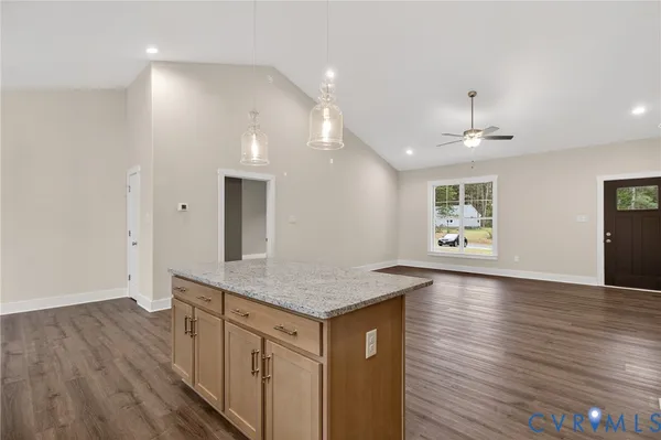 a kitchen with stainless steel appliances granite countertop a sink stove and cabinets