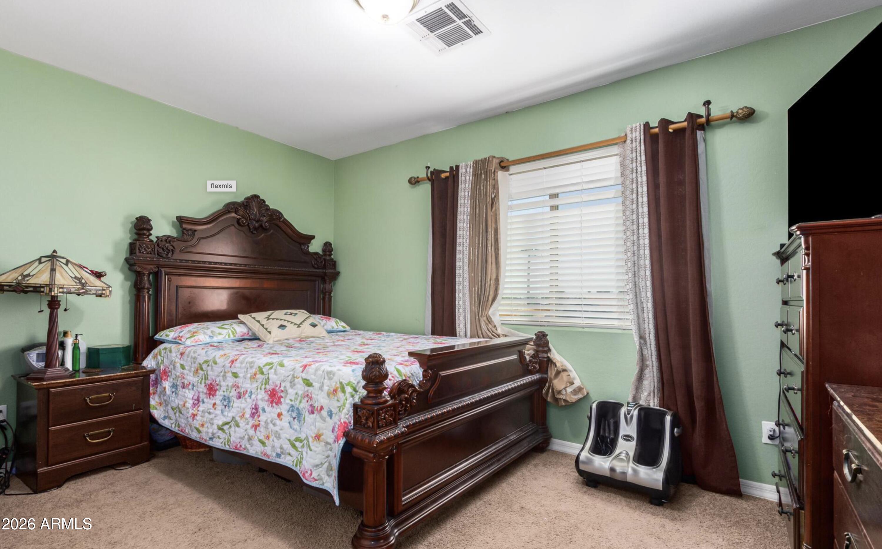 10225 West Camelback Road, Unit 12 Phoenix, AZ 85037 - Photo 11 of 19 a bedroom with a bed and a flat tv screen on wall