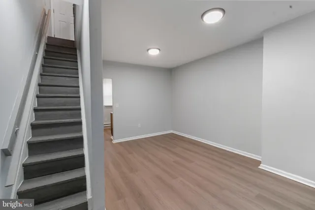 wooden floor in an empty room with stairs
