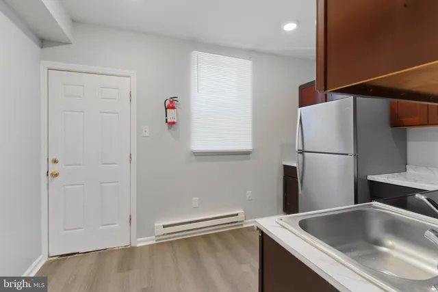 a kitchen with stainless steel appliances granite countertop a refrigerator and a sink