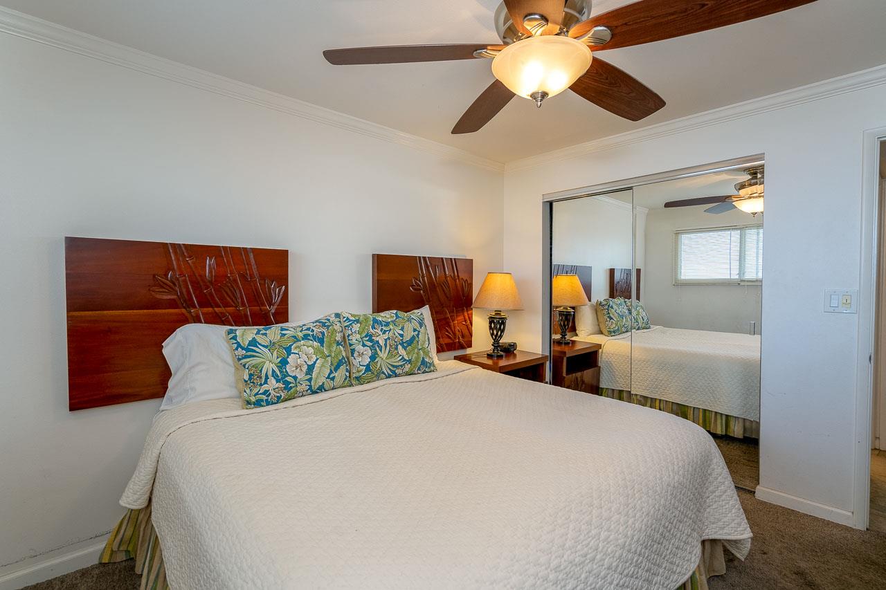 2430 South Kihei Road, Unit 206 Kihei, HI 96753 - Photo 12 of 26 a bedroom with a bed and lamp on the dresser