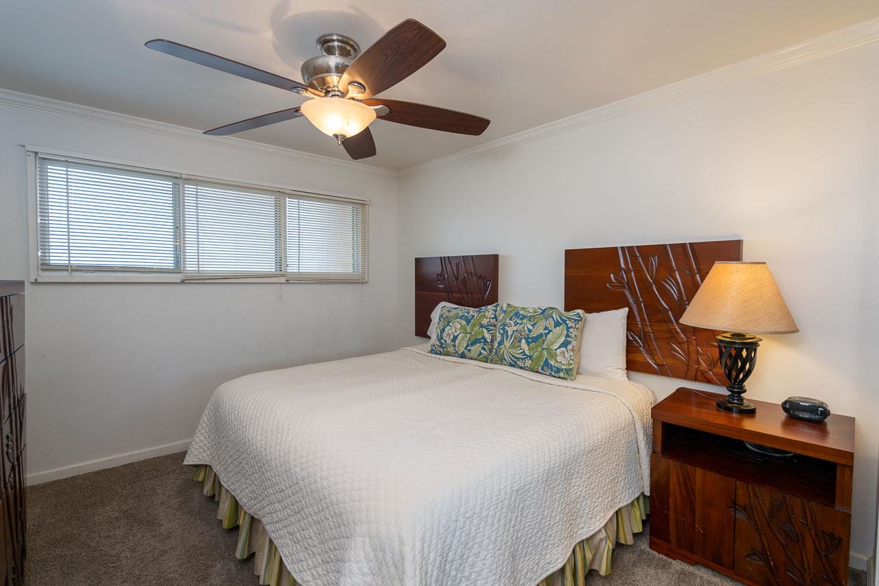 2430 South Kihei Road, Unit 206 Kihei, HI 96753 - Photo 13 of 26 a bedroom with a bed and a lamp