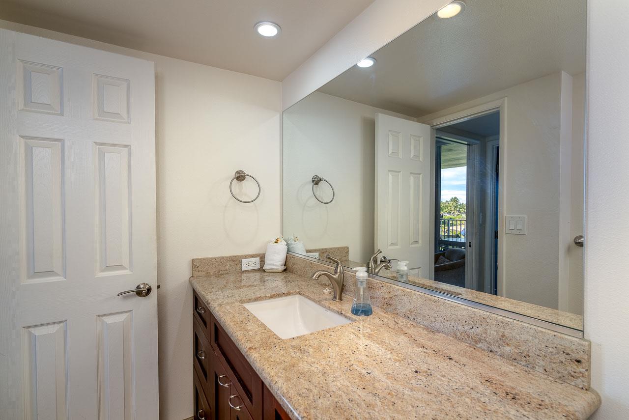 2430 South Kihei Road, Unit 206 Kihei, HI 96753 - Photo 16 of 26 a bathroom with a granite countertop sink and a mirror